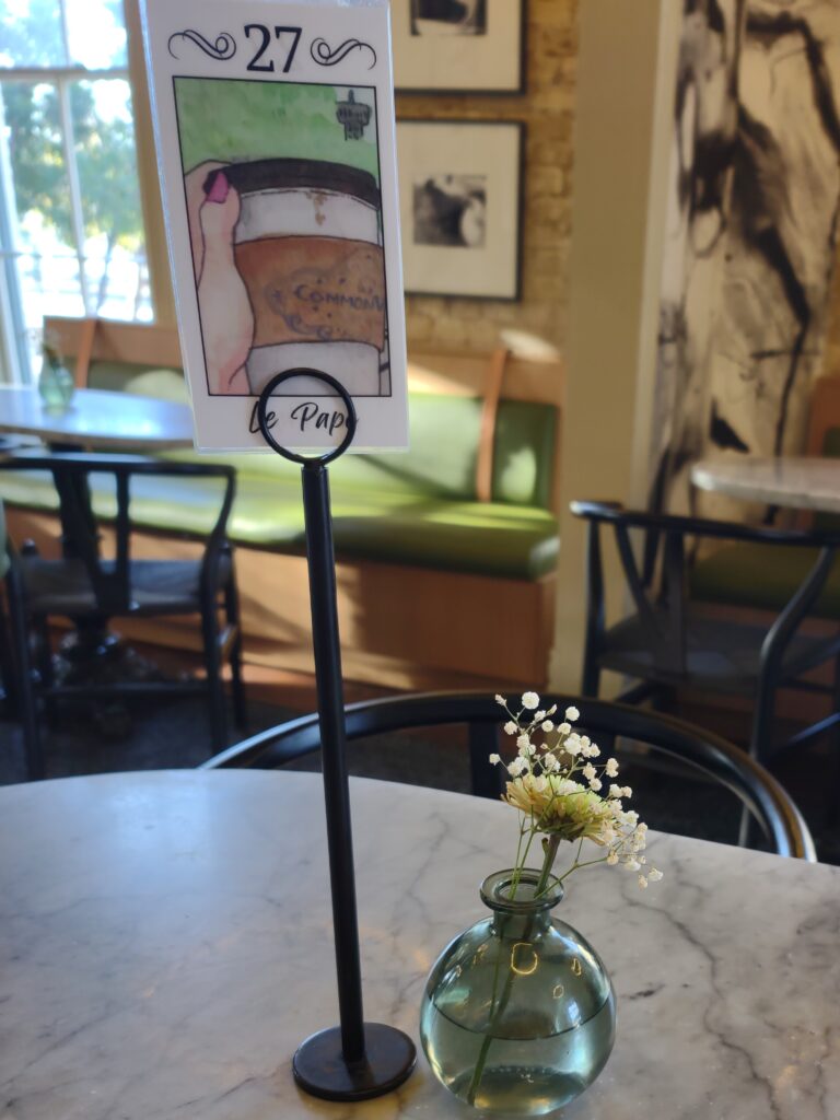 cafe San Antonio, Commonwealth Coffeehouse & Bakery flowers in a vase and a number card in a stand