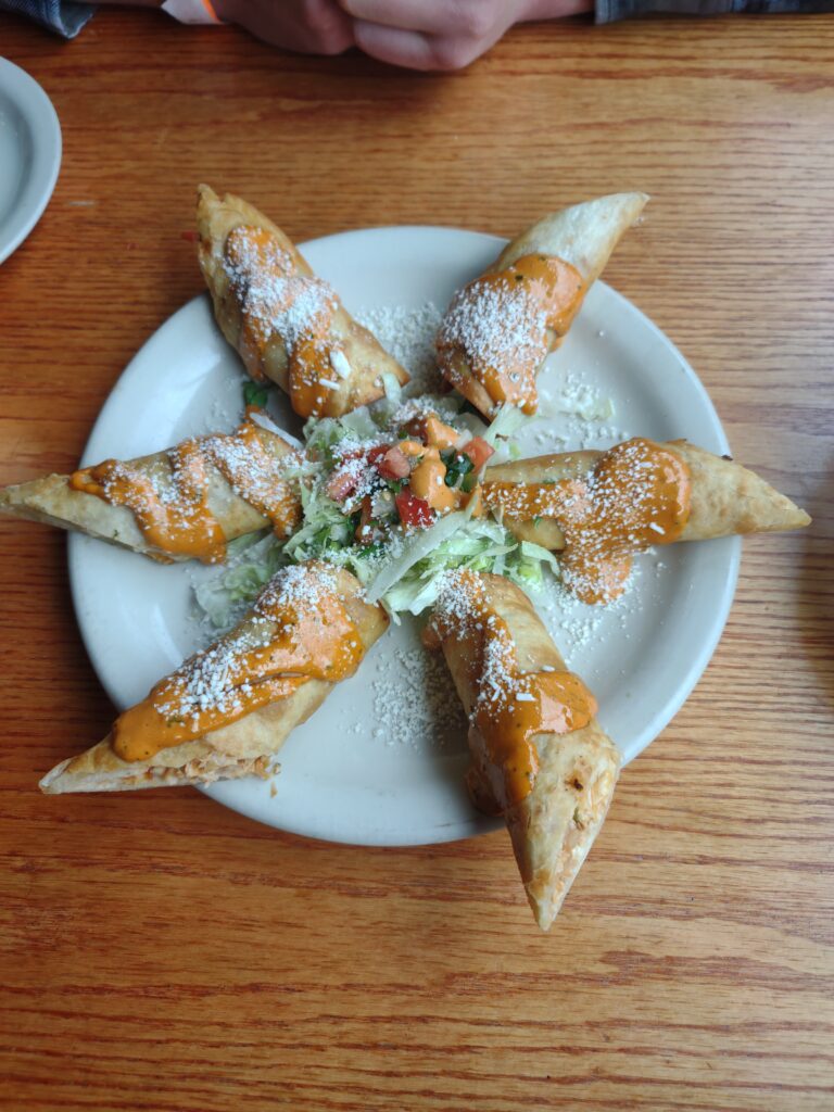 Mexican Food Winchester, VA, El Centro, mexican egg rolls on a plate in a star shape with sauce and salad in the middle